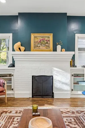 a living room with fireplace furniture and a fireplace