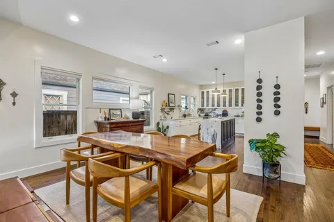 a dining room with furniture and wooden floor
