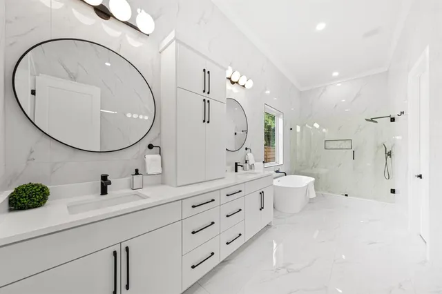 a bathroom with a double vanity sink mirror and toilet