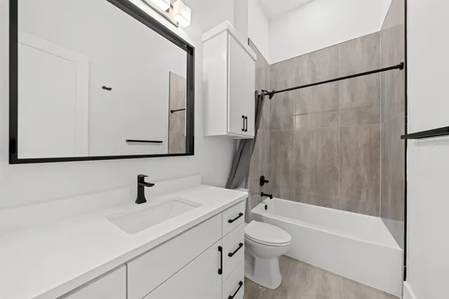 a bathroom with a sink a toilet and a bathtub