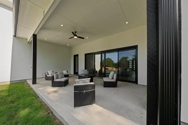 a living room with furniture large window and flat screen tv