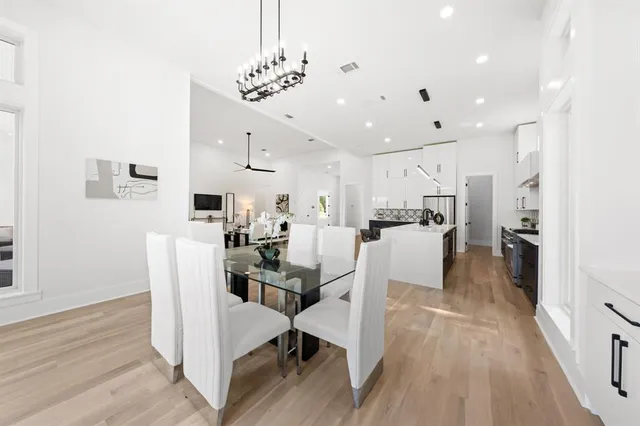 a dining room with furniture and kitchen view