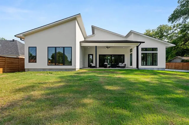 a view of a house with a yard and porch
