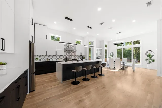 a living room with furniture and view of kitchen