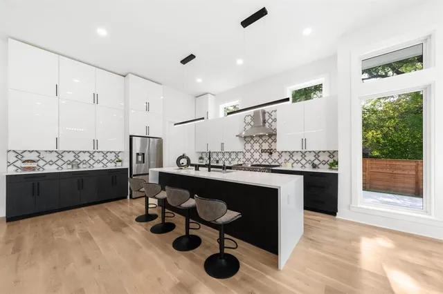 a kitchen with stainless steel appliances kitchen island granite countertop a sink and cabinets