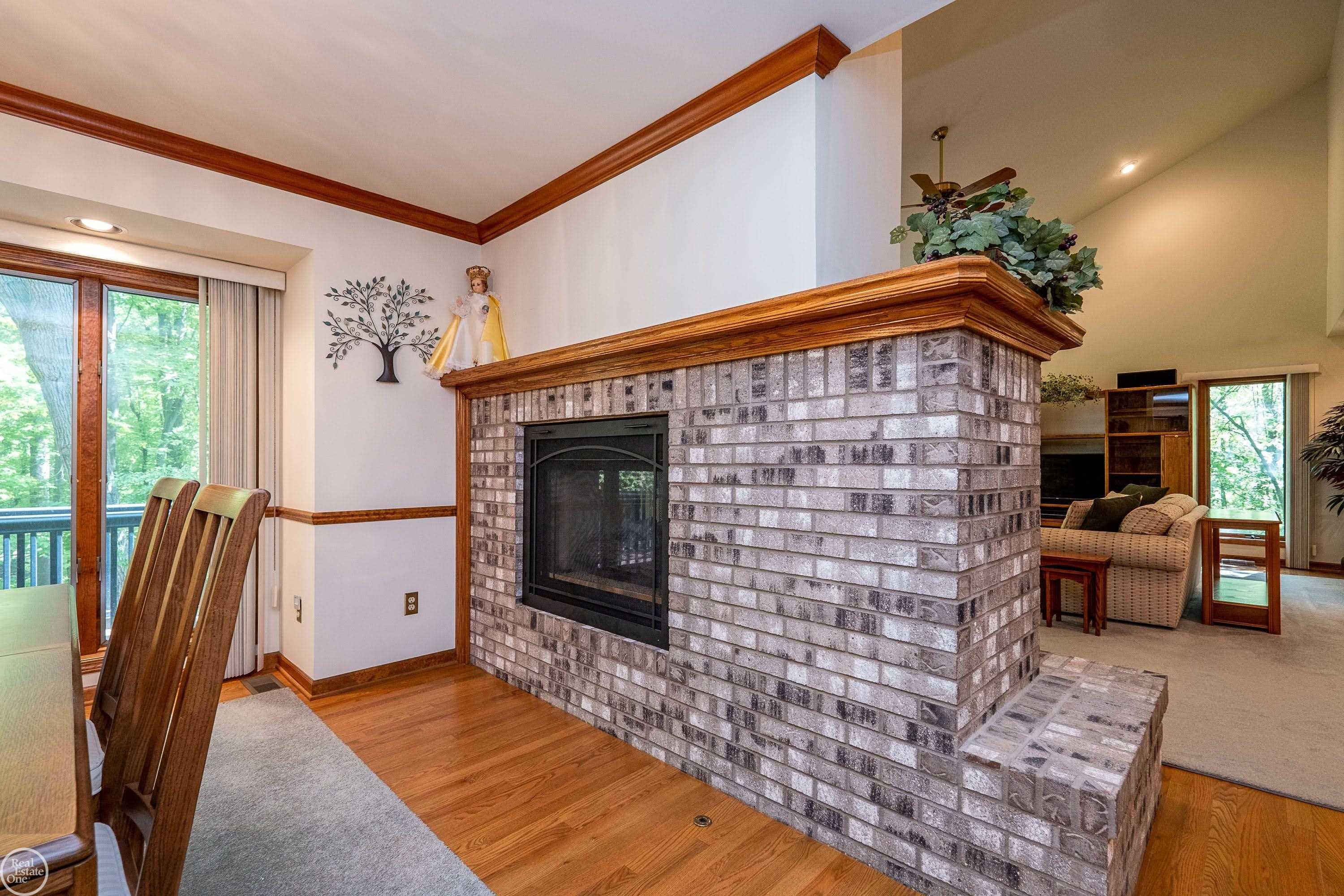448 Mack Road Leonard, MI 48367 - Photo 12 of 73 Double sided fireplace