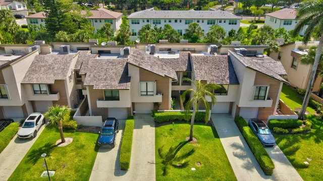 a aerial view of a house with swimming pool lawn chairs and a yard
