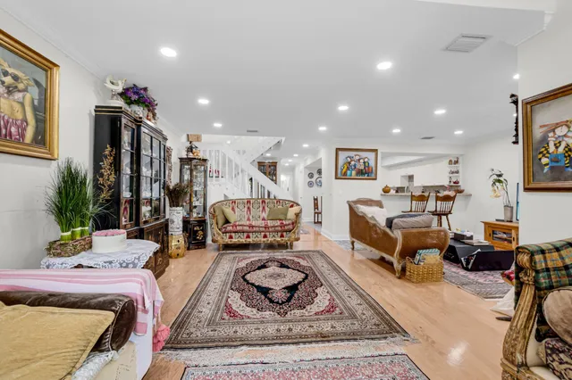 a living room with furniture and a dining table