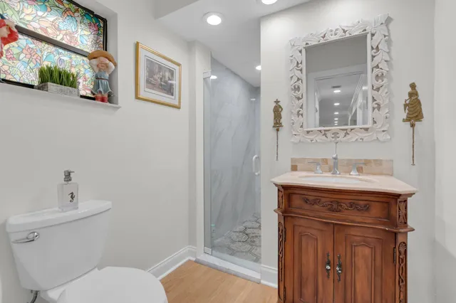 a bathroom with a granite countertop toilet sink and mirror