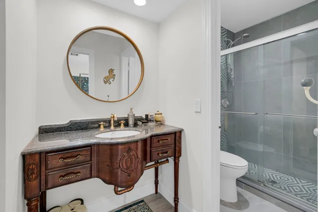 a bathroom with a sink a toilet and a mirror