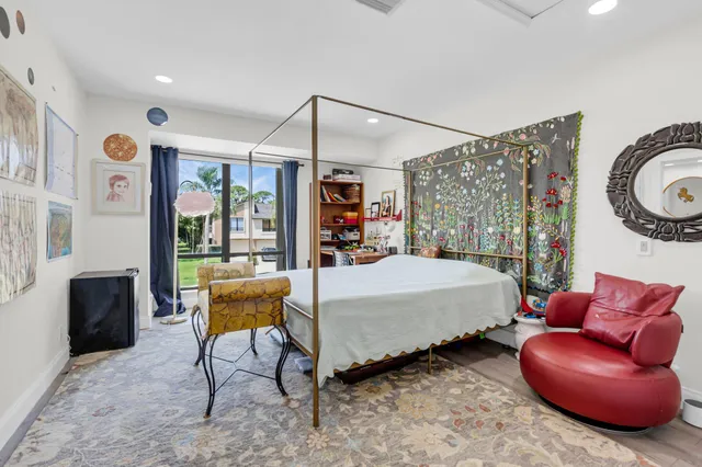 a bed room with a bed and a chair