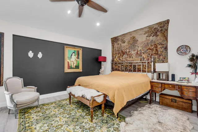 a bed sitting in a bedroom next to a window