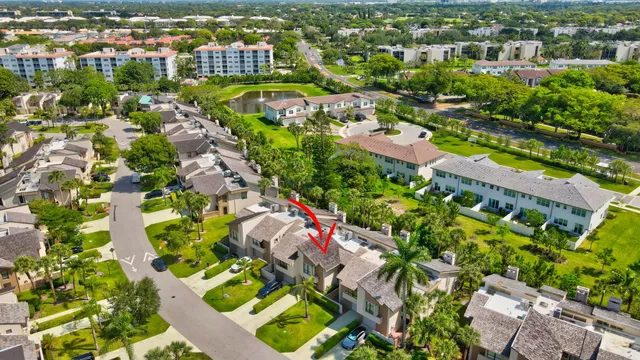an aerial view of residential houses with outdoor space and trees