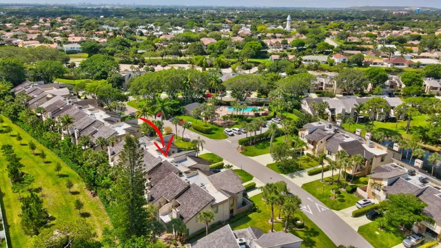 an aerial view of a house with a yard swimming pool and lake view