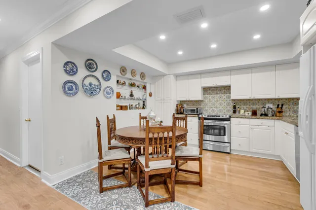 a kitchen with granite countertop white cabinets and chairs