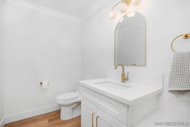 a bathroom with a sink toilet and a mirror