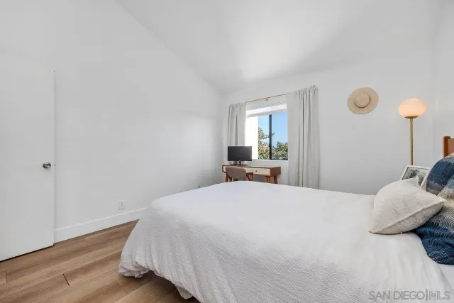 a bedroom with a bed and a large mirror