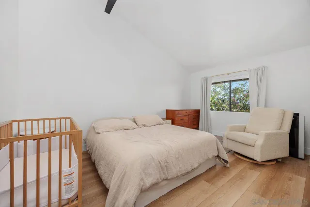 a bedroom with a bed a couch and a window