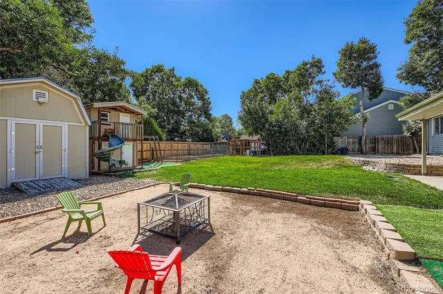 a view of a chairs and table in the backyard