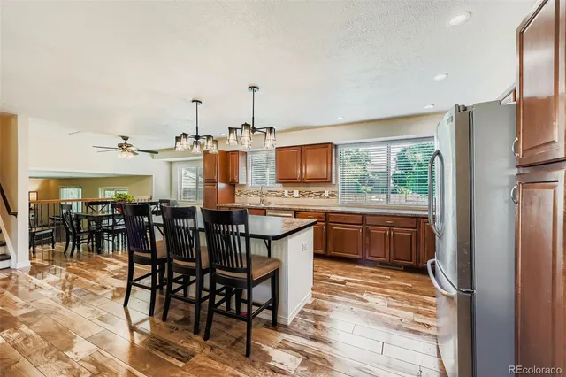 a large kitchen with a table and chairs