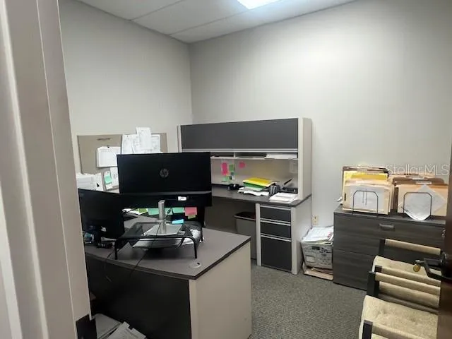 a kitchen with a stove and a flat screen tv