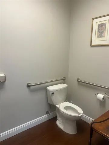a white toilet sitting next to a white walls
