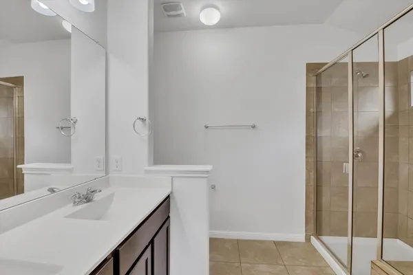 a bathroom with a glass shower door
