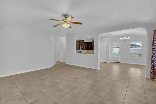 a large kitchen with a stove top oven a sink and dishwasher a refrigerator with wooden cabinets