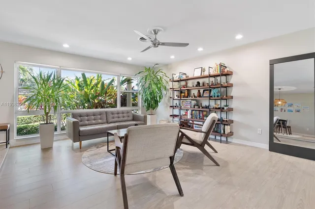 a living room with furniture and a large window