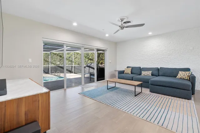 a view of a dining room with furniture wooden floor and a chandelier