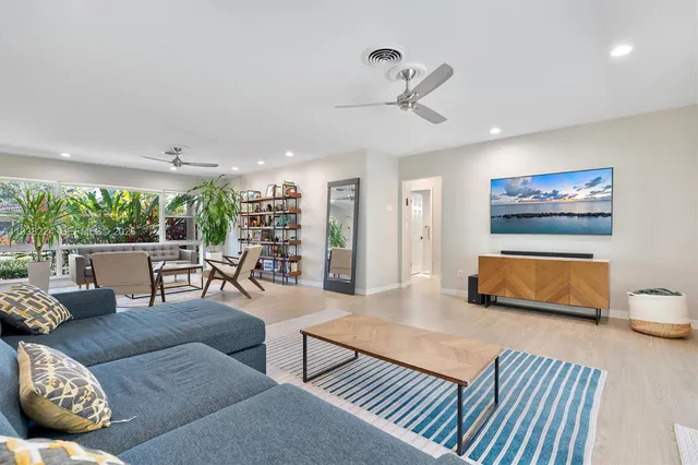 a kitchen with stainless steel appliances granite countertop a refrigerator a stove and a sink