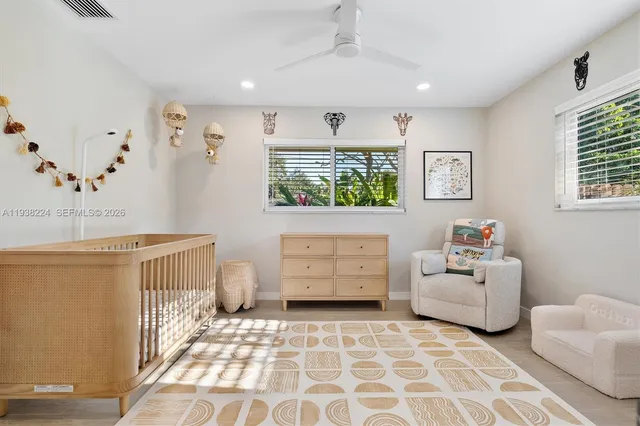 a work room with furniture and view of kitchen