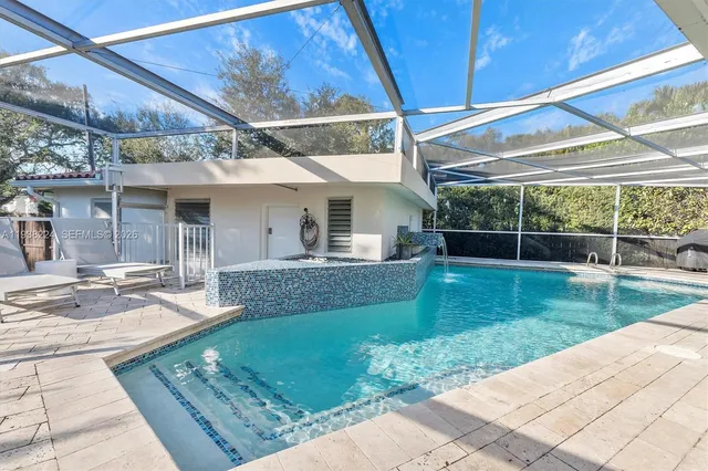 an aerial view of a house with outdoor space and street view