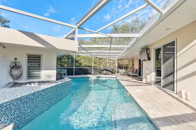 an aerial view of a house with a garden and a yard