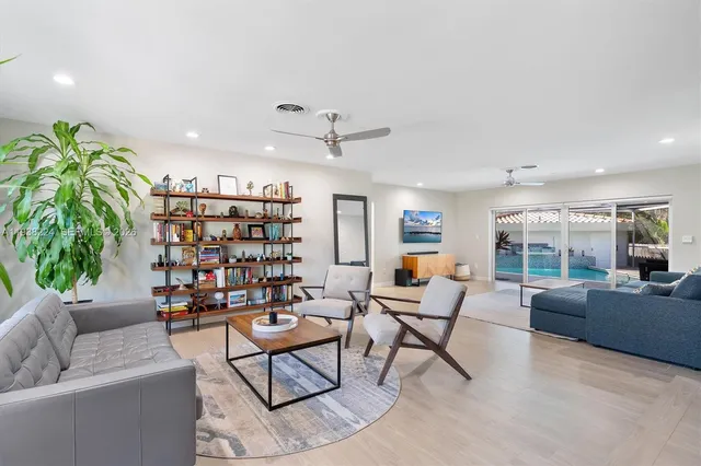 a living room with furniture and a potted plant