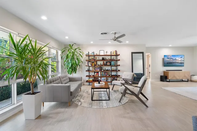 a living room with furniture and a book shelf