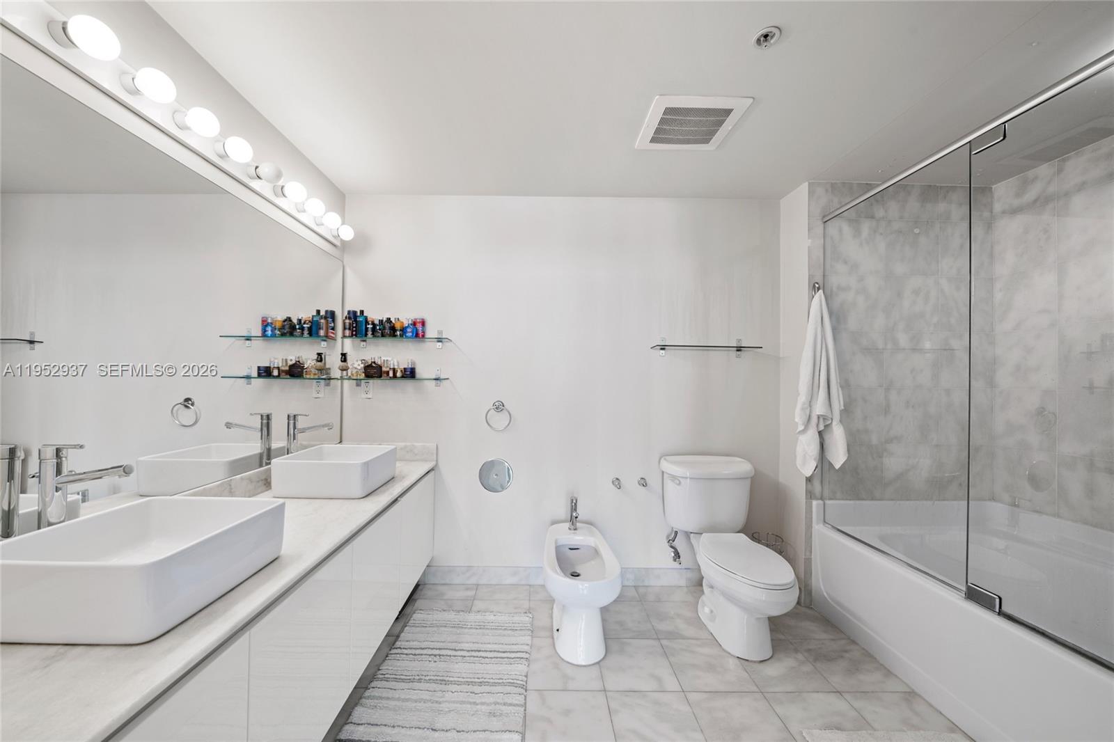 601 Northeast 36th Street, Unit 1704 Miami, FL 33137 - Photo 12 of 18 a bathroom with a toilet sink and shower