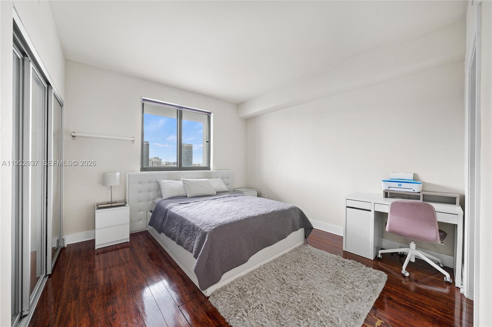 601 Northeast 36th Street, Unit 1704 Miami, FL 33137 - Photo 13 of 18 a bedroom with a bed and a chair in it