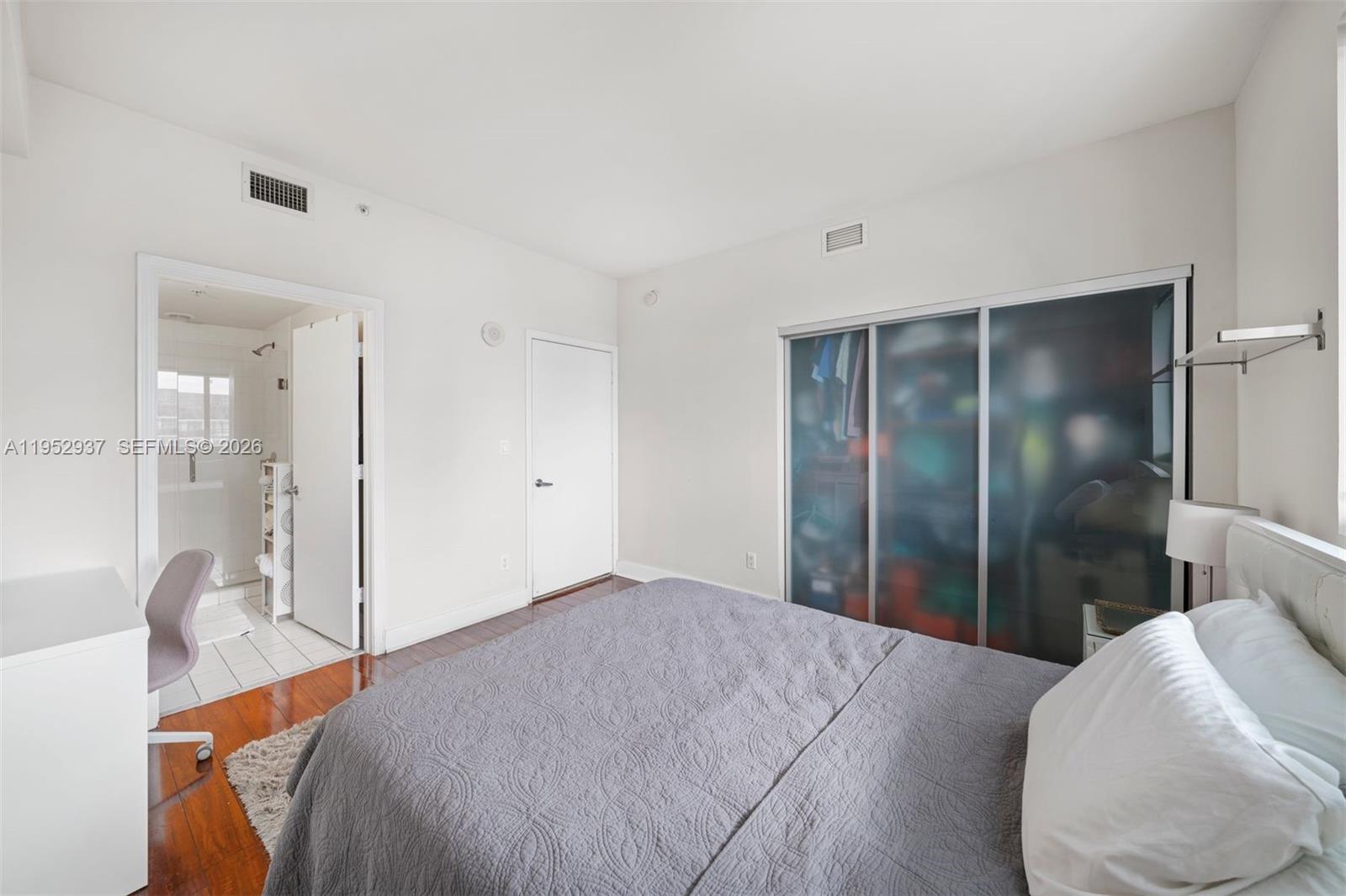 601 Northeast 36th Street, Unit 1704 Miami, FL 33137 - Photo 13 of 19 a bedroom with a bed and a glass door