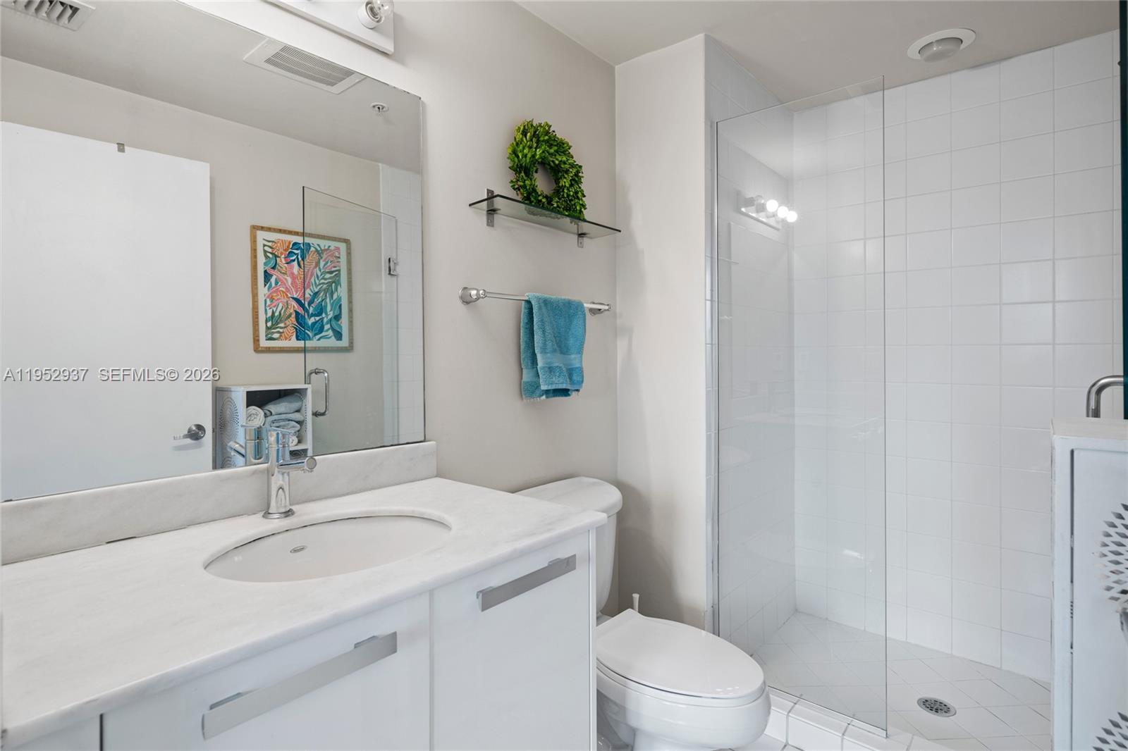 601 Northeast 36th Street, Unit 1704 Miami, FL 33137 - Photo 16 of 19 a bathroom with a granite countertop sink a toilet and shower