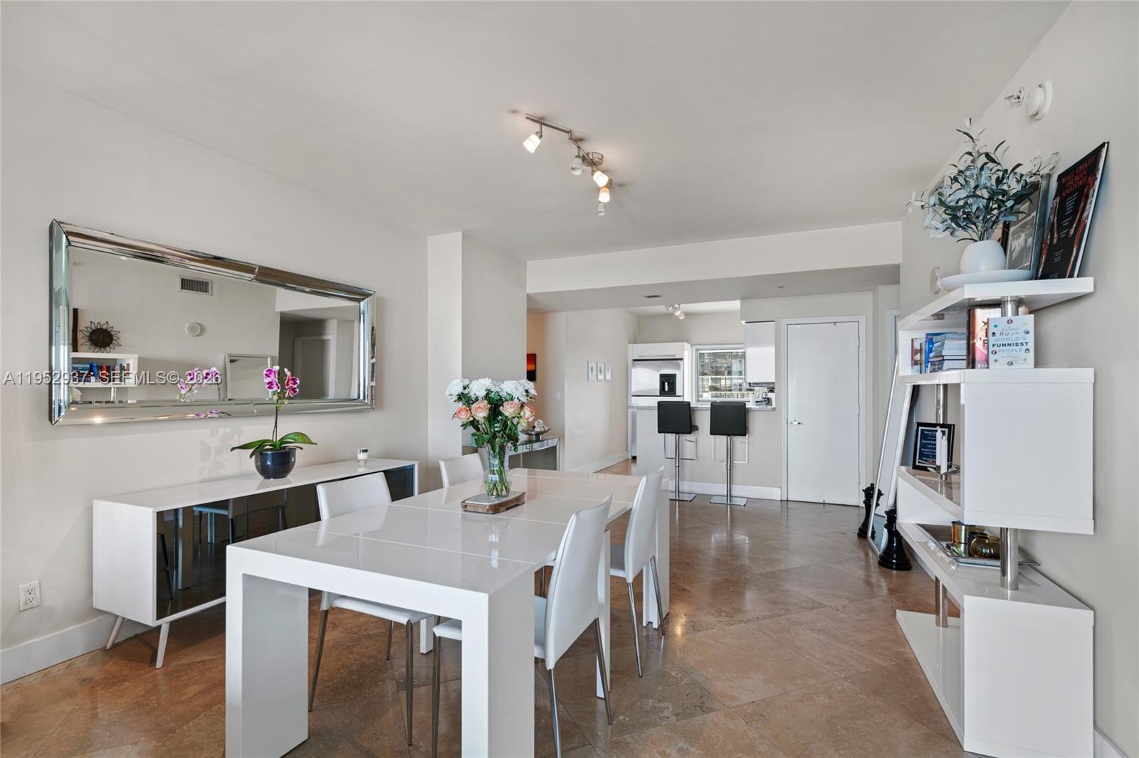 601 Northeast 36th Street, Unit 1704 Miami, FL 33137 - Photo 7 of 18 a view of kitchen island with furniture and wooden floor