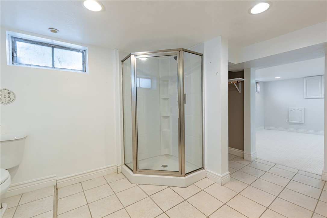 5235 West Ridgewood Road Springfield, OH 45503 - Photo 26 of 32 This lower level bathroom features a convenient corner shower and durable tile flooring.
