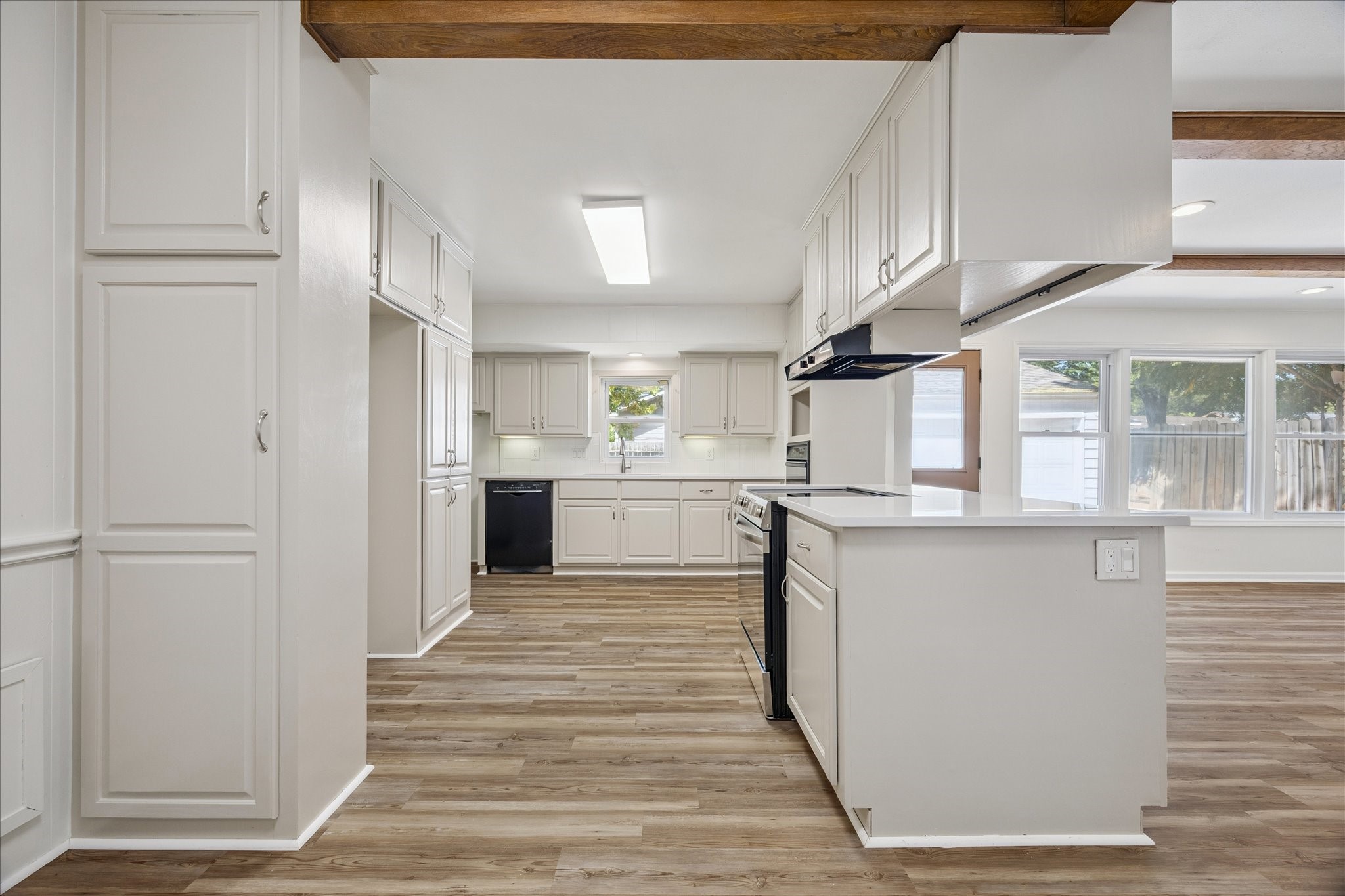 9014 Dunlap Street Houston, TX 77074 - Photo 4 of 23 The kitchen offers an abundance of cabinetry and generous prep space, complemented by double overs and a charming window with views of the backyard.