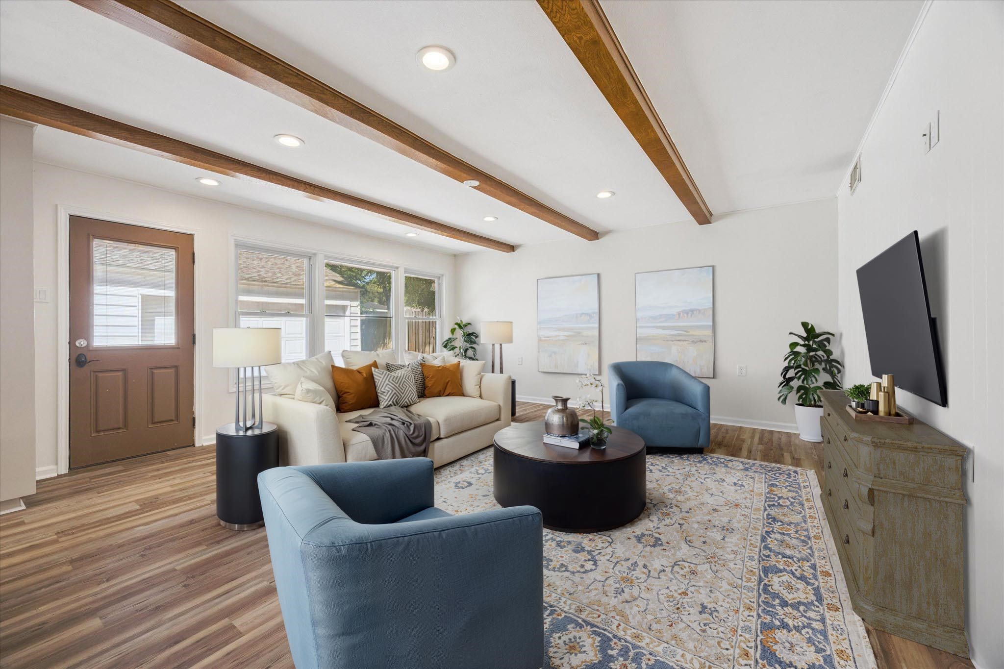 9014 Dunlap Street Houston, TX 77074 - Photo 8 of 23 The family room offers a spacious setting designed for both comfortable relaxation and effortless entertaining, with neutral colors that enhance the warm and welcoming ambiance. *Virtually staged.*