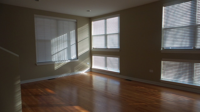 1244 West Monroe Street, Unit 1 Chicago, IL 60607 - Photo 12 of 25 a view of an empty room with wooden floor and a window