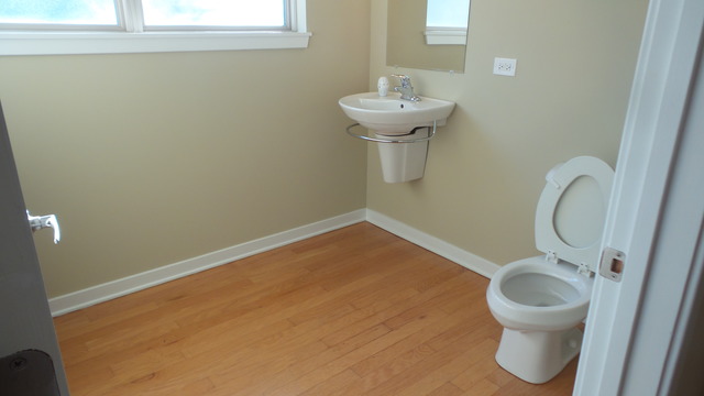 1244 West Monroe Street, Unit 1 Chicago, IL 60607 - Photo 8 of 25 a bathroom with a toilet sink and a mirror
