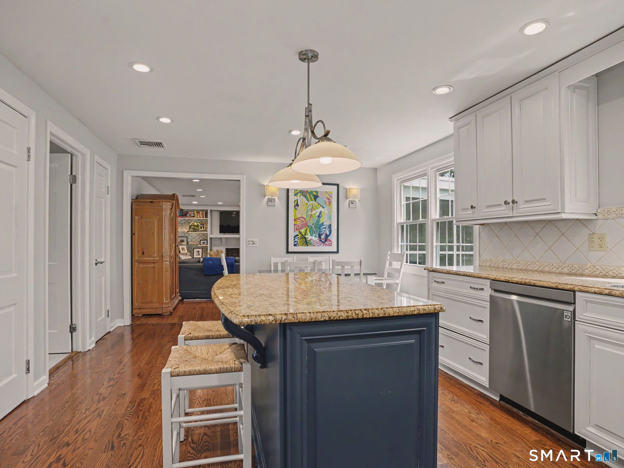 45 Wendover Road Trumbull, CT 06611 - Photo 14 of 33 Updated Kitchen with granite counters, tiled backsplash and white cabinetry.
