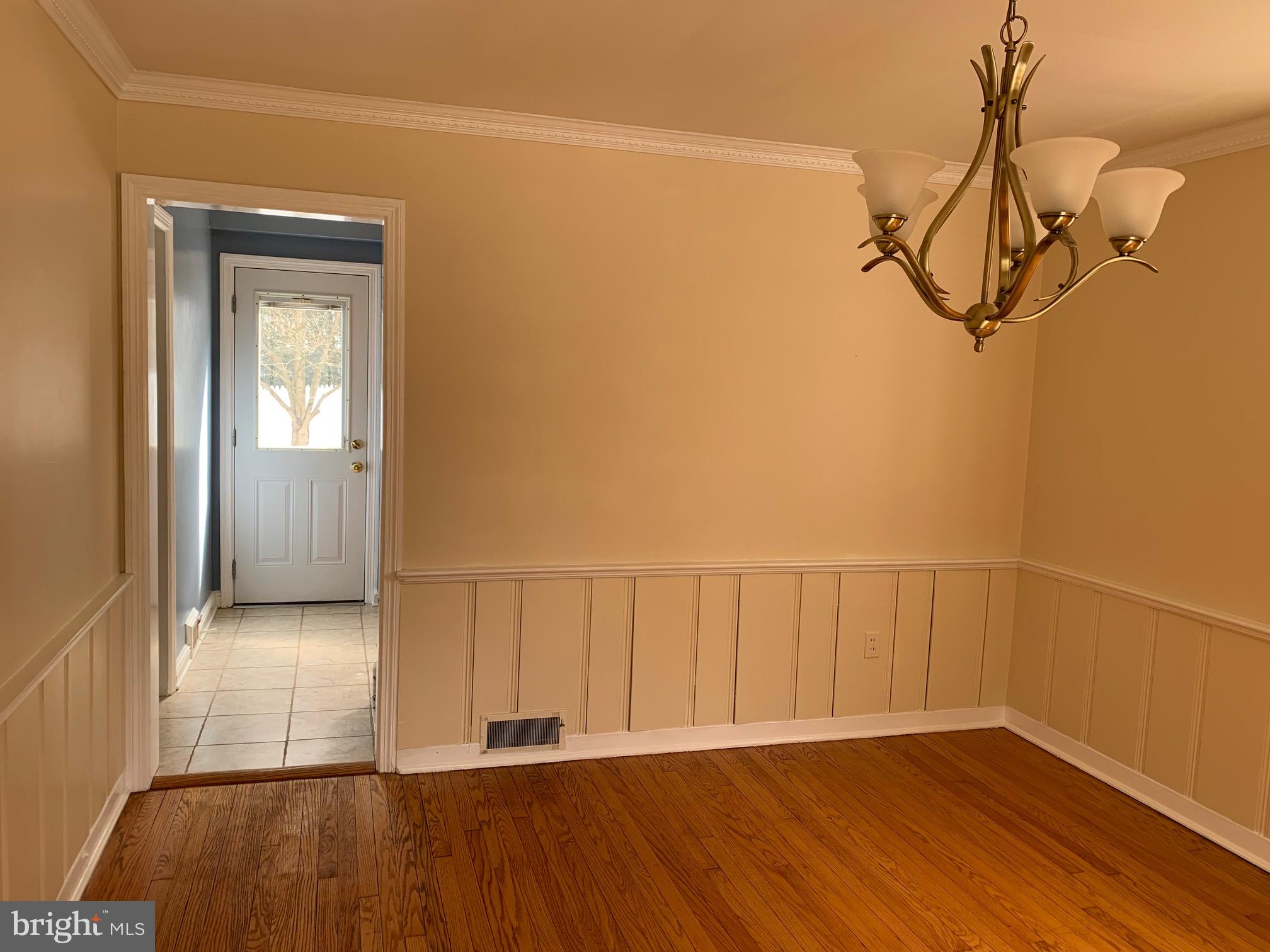 7807 Glenbrook Road Bethesda, MD 20814 - Photo 10 of 25 Dining room with wainscoting and crown molding