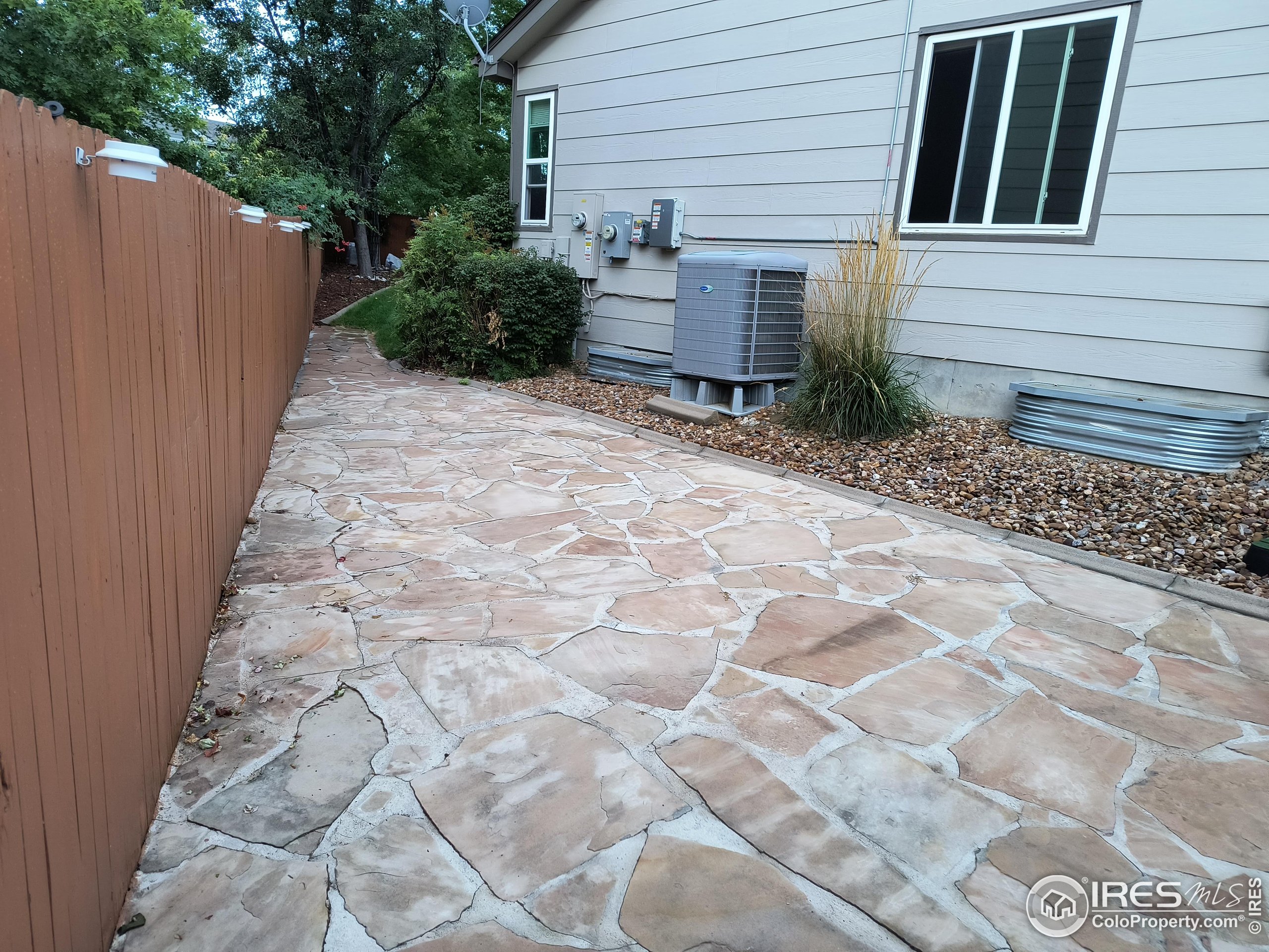 5740 High Street Frederick, CO 80504 - Photo 28 of 34 a view of backyard with potted plants and wooden fence