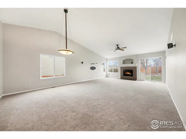 a view of empty room with fireplace and fan
